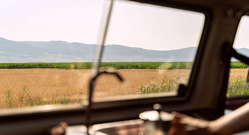 Looking out at the countryside from the window of a campervan.