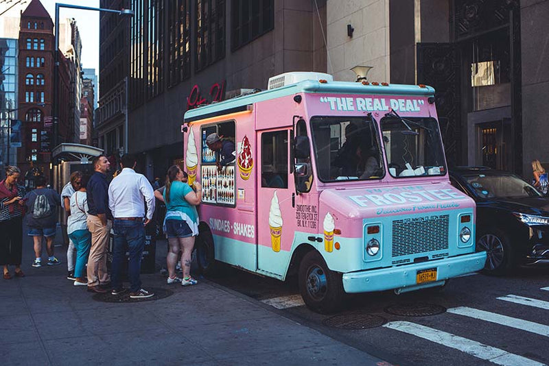 People are lining up at an ice-cream truck